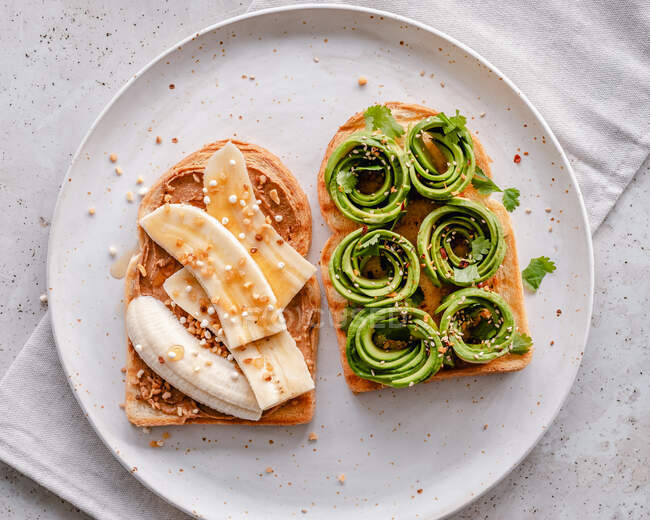 Banana and avocado toast served on plate — Stock Photo