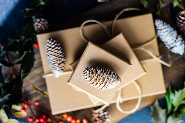 Gifts boxes with pine cones, top view — Stock Photo