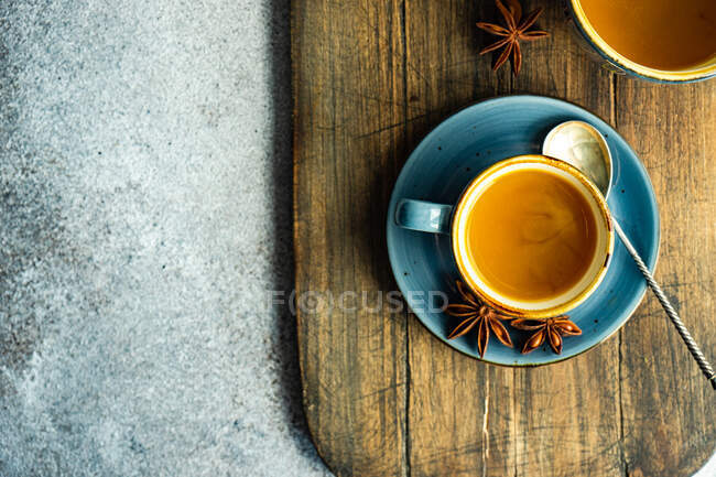 Top view of turmeric tea served on chopping board — Stock Photo