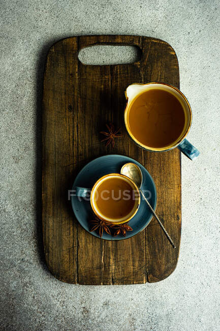Top view of turmeric tea served on chopping board — Stock Photo