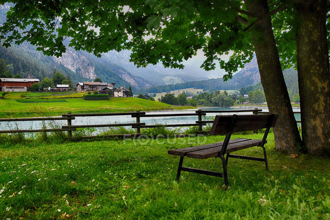 Bench by a lake, Brusson, Val d'Ayas, Aosta Valley, Italy — стокове фото