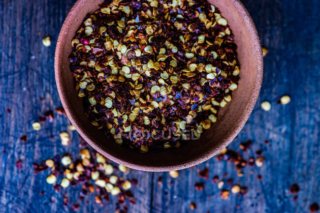 Overhead view of bowl of dried chili pepper flakes — Stock Photo