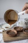 Ручной налив жидкого шоколада в пирог — стоковое фото