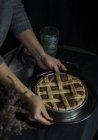 Human hands holding freshly baked pie — Stock Photo