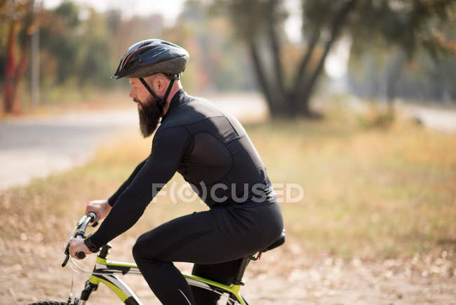 Barbudo hombre ciclismo en el parque - foto de stock