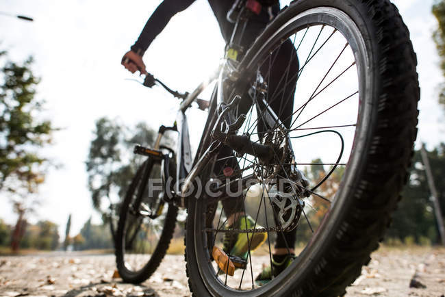 Man in sportswear with bicycle — Stock Photo