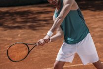 Colpo ritagliato di giocatore di tennis facendo colpo con racchetta — Foto stock