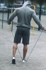 Rear view of sportsman jumping rope at sports ground — Stock Photo