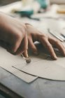Cropped shot of craftsman tracing leather sheets to create shoes — Stock Photo