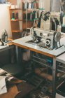 Lieu de travail de couturière à l'atelier de tailleur avec machine à coudre industrielle électrique — Photo de stock