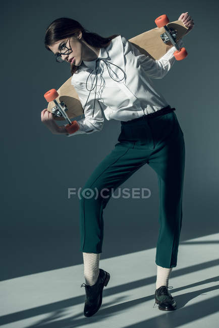 Hipster woman with skateboard — Stock Photo