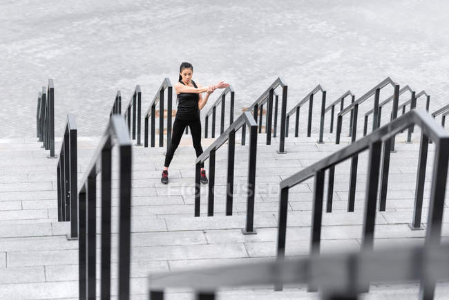 Sportswoman formation sur les escaliers du stade — Photo de stock