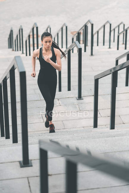 Sportswoman formation sur les escaliers du stade — Photo de stock