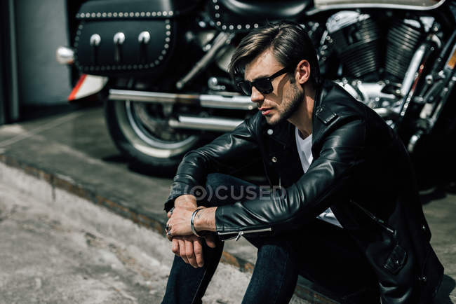 Stylish man with motorbike — Stock Photo