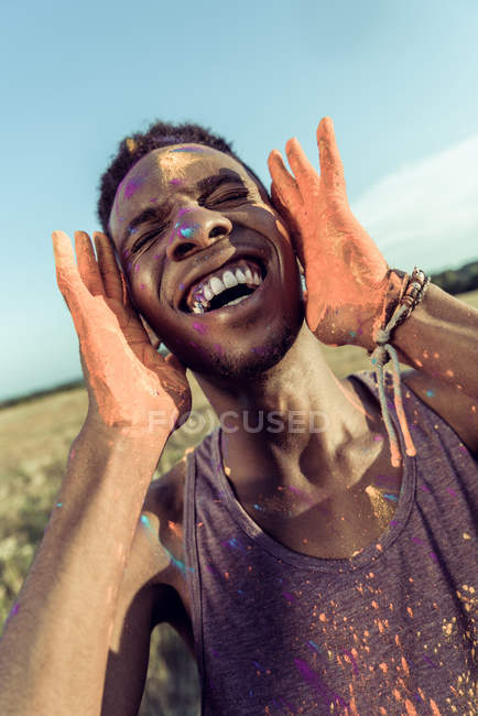 African american man at holi festival — Stock Photo