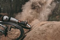 Cropped image of dust after racer riding bike — Stock Photo