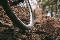 Cropped image of bicycle wheel on the track — Stock Photo